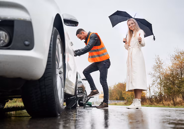 cheerful-emergency-mechanic-repairing-woman-car-street
