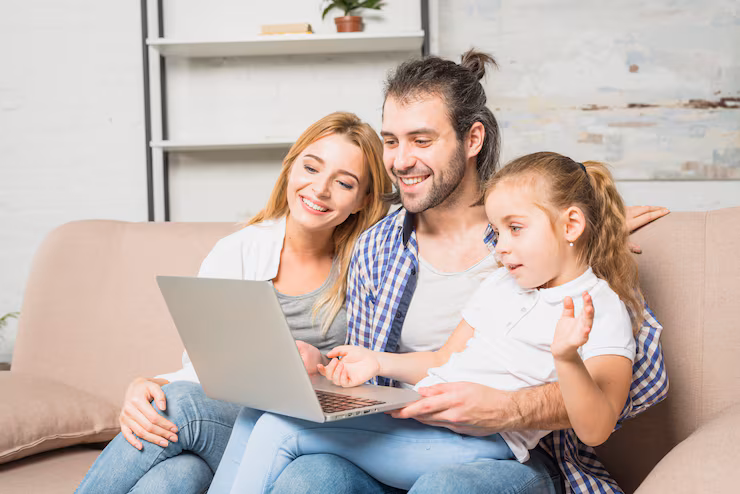family-using-laptop-sofa